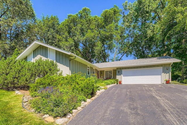 1755 Ranier Ln N, Plymouth, MN 55447 - ranch-style house featuring a garage, board and batten siding, and asphalt driveway
