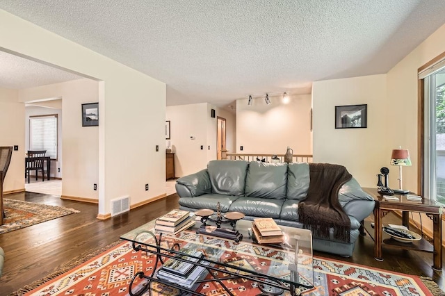 1755 Ranier Ln N, Plymouth, MN 55447 - living area with wood finished floors, healthy amount of natural light, and a textured ceiling