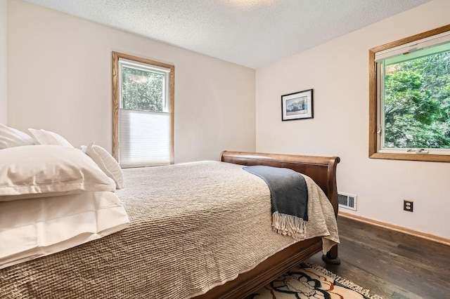 1755 Ranier Ln N, Plymouth, MN 55447 - bedroom featuring multiple windows, wood finished floors, and a textured ceiling