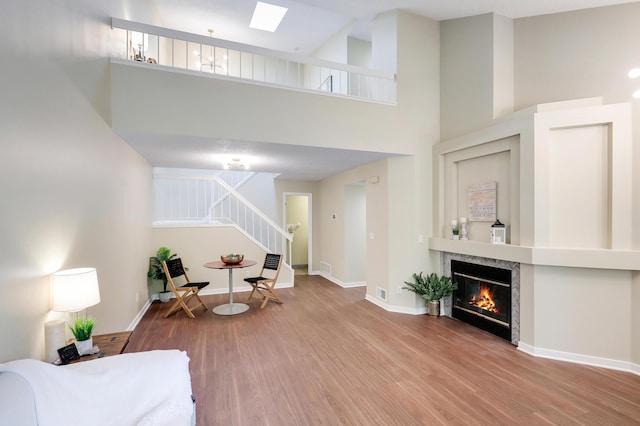 2145 Shenandoah Ct Unit D, Plymouth, MN 55447 - living room featuring stairway, a towering ceiling, wood finished floors, and a fireplace