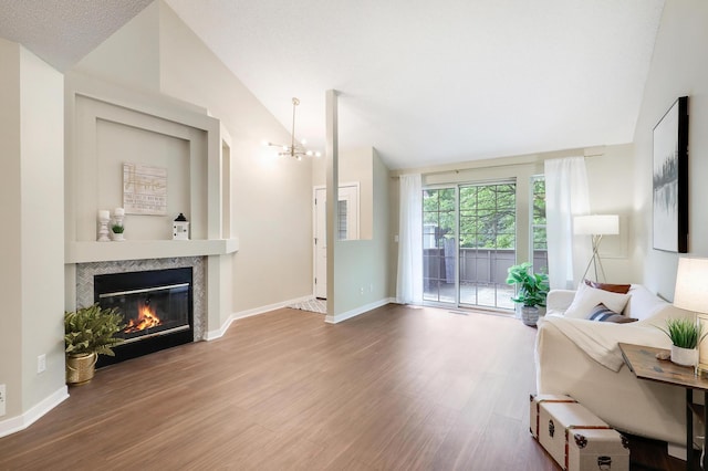 2145 Shenandoah Ct Unit D, Plymouth, MN 55447 - living room with vaulted ceiling, wood finished floors, a tile fireplace, and a chandelier