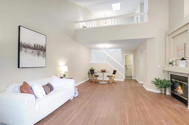 2145 Shenandoah Ct Unit D, Plymouth, MN 55447 - living area with wood finished floors, a high ceiling, stairway, and a glass covered fireplace