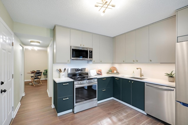 2145 Shenandoah Ct Unit D, Plymouth, MN 55447 - kitchen featuring stainless steel appliances, light wood-style flooring, light countertops, and a textured ceiling