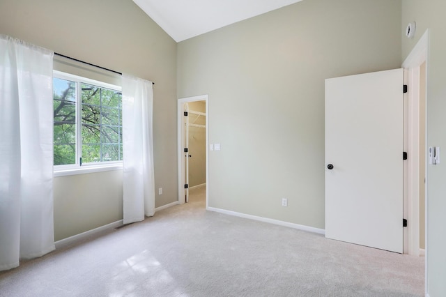 2145 Shenandoah Ct Unit D, Plymouth, MN 55447 - unfurnished bedroom featuring carpet flooring, high vaulted ceiling, and a walk in closet