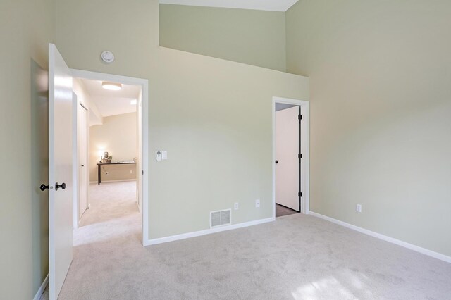 2145 Shenandoah Ct Unit D, Plymouth, MN 55447 - unfurnished bedroom featuring carpet and a towering ceiling