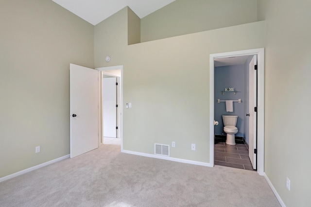 2145 Shenandoah Ct Unit D, Plymouth, MN 55447 - unfurnished bedroom featuring carpet flooring, high vaulted ceiling, and connected bathroom