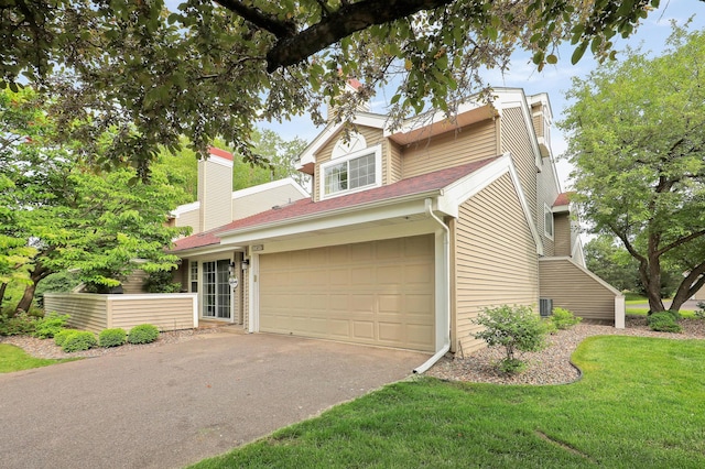 2145 Shenandoah Ct Unit D, Plymouth, MN 55447 - view of front of home featuring driveway, a chimney, a front lawn, and a garage