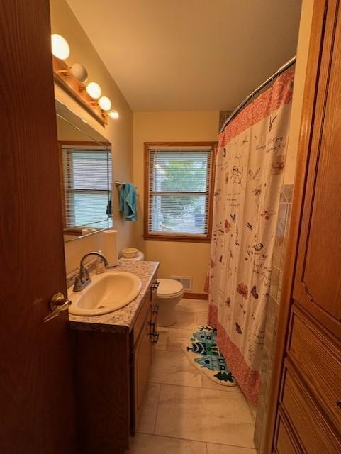137 20th Ave S, Saint Cloud, MN 56301 - full bathroom featuring vanity, curtained shower, and tile patterned floors