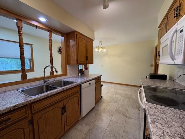 137 20th Ave S, Saint Cloud, MN 56301 - kitchen featuring white appliances, brown cabinetry, a chandelier, recessed lighting, and light countertops