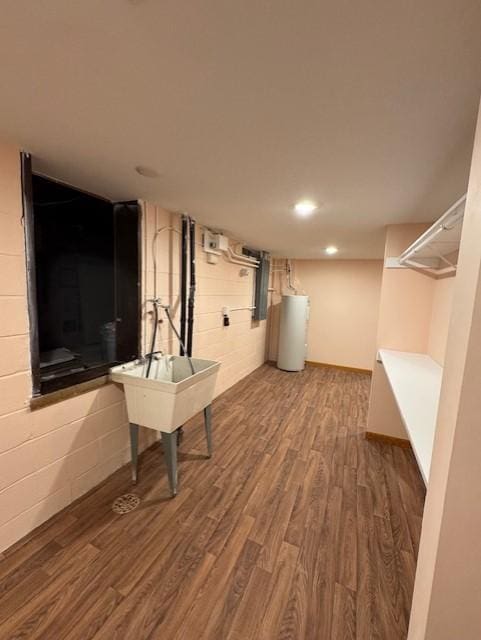 137 20th Ave S, Saint Cloud, MN 56301 - finished below grade area with water heater, wood finished floors, recessed lighting, and concrete block wall