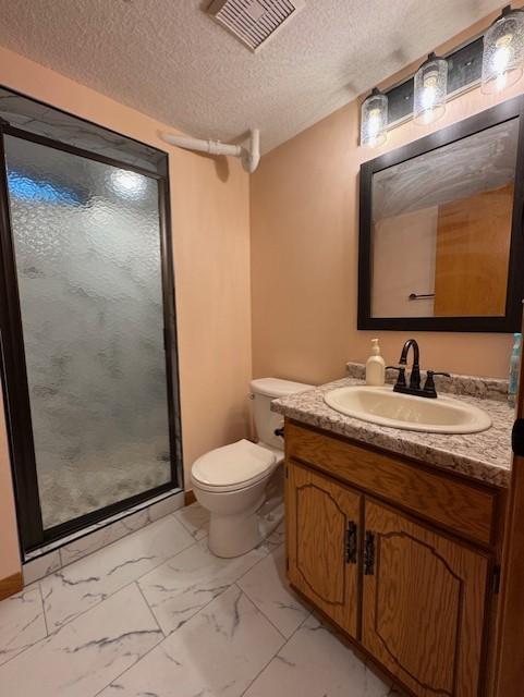137 20th Ave S, Saint Cloud, MN 56301 - bathroom featuring marble look tile flooring, vanity, a stall shower, and a textured ceiling