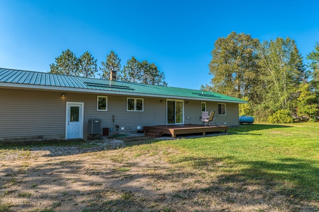 329 Kelliher Rd SW, Kelliher, MN 56650 - back of property featuring a wooden deck, a lawn, a metal roof, and a chimney