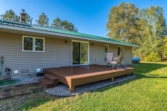 329 Kelliher Rd SW, Kelliher, MN 56650 - rear view of property with a lawn, a metal roof, a wooden deck, and crawl space