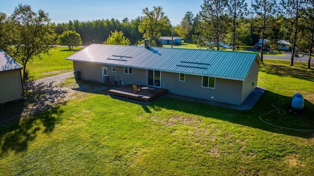 329 Kelliher Rd SW, Kelliher, MN 56650 - back of house with a yard, a metal roof, and a deck