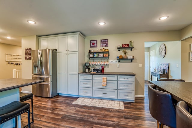 329 Kelliher Rd SW, Kelliher, MN 56650 - kitchen with stainless steel fridge, dark wood finished floors, recessed lighting, and dark countertops
