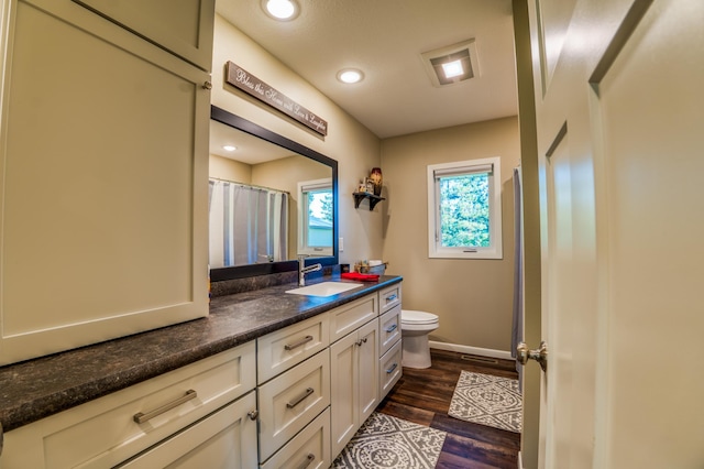329 Kelliher Rd SW, Kelliher, MN 56650 - bathroom featuring vanity, wood finished floors, recessed lighting, and curtained shower