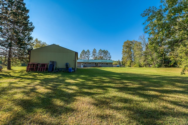 329 Kelliher Rd SW, Kelliher, MN 56650 - view of green lawn with an outbuilding