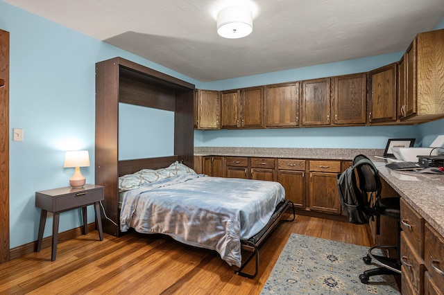 8544 Demontreville Trl N, Lake Elmo, MN 55042 - bedroom featuring built in study area and wood finished floors