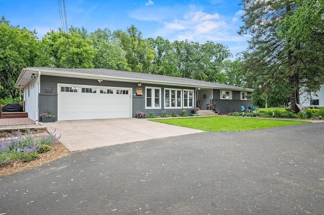 8544 Demontreville Trl N, Lake Elmo, MN 55042 - view of front of house featuring an attached garage, concrete driveway, brick siding, and a front lawn