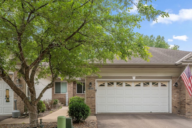 14208 Heritage Ln, Apple Valley, MN 55124 - view of front of property with brick siding, driveway, a shingled roof, and an attached garage