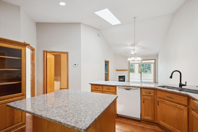 14208 Heritage Ln, Apple Valley, MN 55124 - kitchen featuring dishwasher, vaulted ceiling, a skylight, light wood-style floors, and a center island