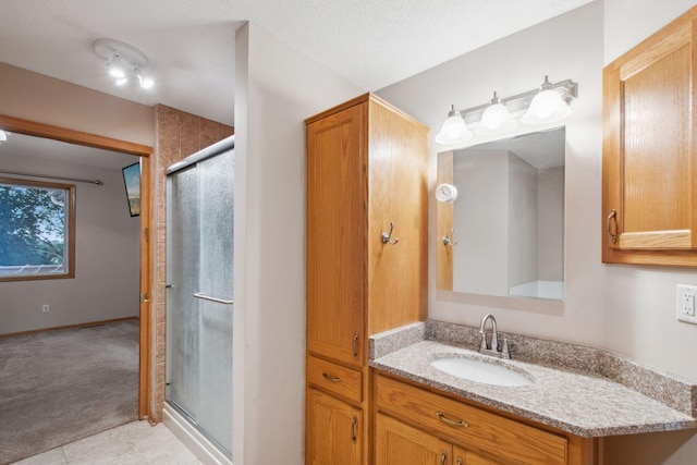 14208 Heritage Ln, Apple Valley, MN 55124 - bathroom with a stall shower, vanity, and tile patterned flooring