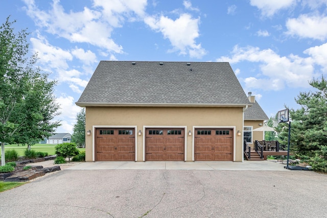 19270 Foxfield Dr, Credit River Twp, MN 55372 - view of home's exterior featuring stucco siding, a garage, driveway, and a shingled roof