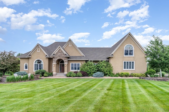 19270 Foxfield Dr, Credit River Twp, MN 55372 - traditional-style home with stucco siding, a front lawn, stone siding, and a shingled roof