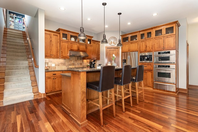 19270 Foxfield Dr, Credit River Twp, MN 55372 - kitchen with brown cabinets, a warming drawer, stainless steel appliances, and recessed lighting