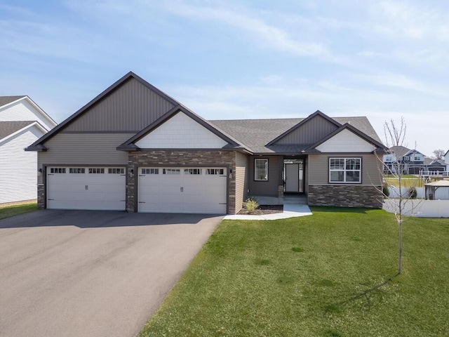 1136 168th Ln NW, Andover, MN 55304 - craftsman-style home featuring stone siding, asphalt driveway, a front lawn, a garage, and roof with shingles