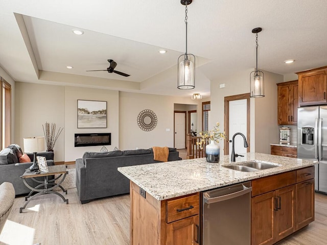 1136 168th Ln NW, Andover, MN 55304 - kitchen featuring appliances with stainless steel finishes, open floor plan, light wood-style floors, hanging light fixtures, and a ceiling fan