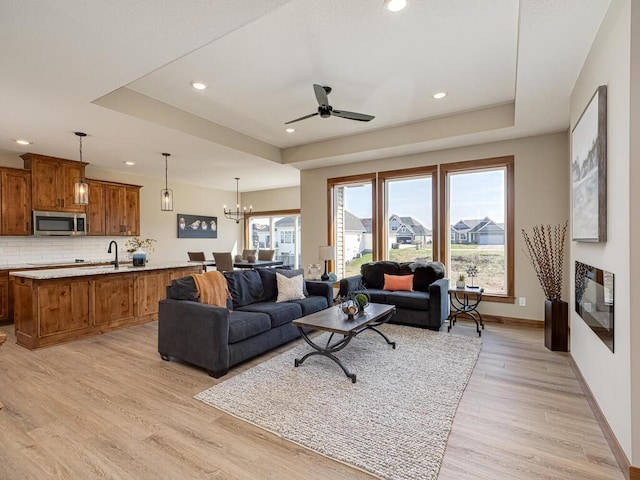 1136 168th Ln NW, Andover, MN 55304 - living area with a raised ceiling, light wood-type flooring, ceiling fan, and recessed lighting