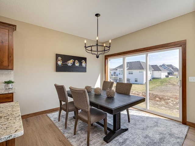 1136 168th Ln NW, Andover, MN 55304 - dining area with a chandelier, light wood-style flooring, and a residential view