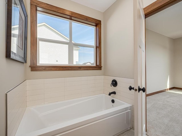 1136 168th Ln NW, Andover, MN 55304 - bathroom featuring a bath and baseboards