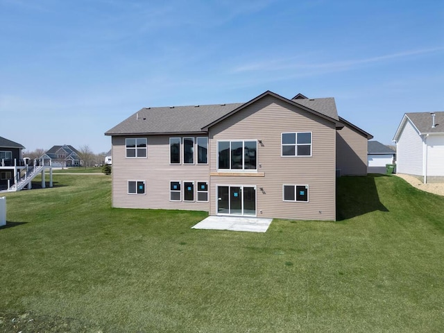 1136 168th Ln NW, Andover, MN 55304 - rear view of house with a yard, a patio, and a shingled roof