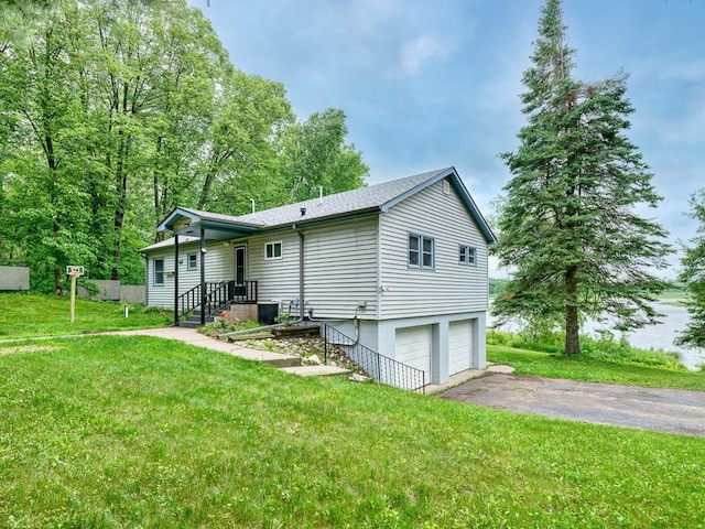 27012 Bluebill Point Rd, Roosevelt Twp, MN 56450 - back of property with an attached garage, driveway, a lawn, and roof with shingles