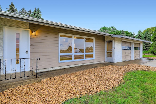 12258 Crooked Lake Blvd NW, Coon Rapids, MN 55433 - exterior space with a garage
