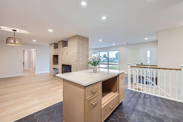 12258 Crooked Lake Blvd NW, Coon Rapids, MN 55433 - kitchen with open floor plan, recessed lighting, a brick fireplace, a center island, and dark tile patterned flooring