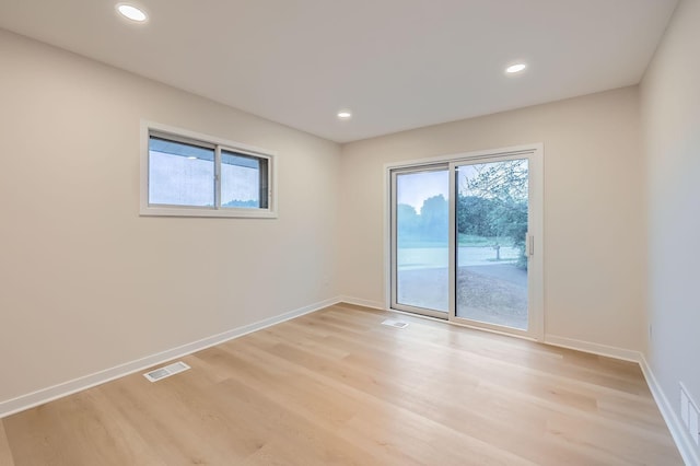 12258 Crooked Lake Blvd NW, Coon Rapids, MN 55433 - empty room featuring light wood-style floors, plenty of natural light, and recessed lighting