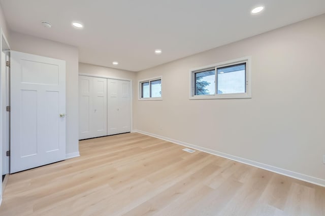 12258 Crooked Lake Blvd NW, Coon Rapids, MN 55433 - unfurnished bedroom featuring light wood-type flooring, recessed lighting, and a closet