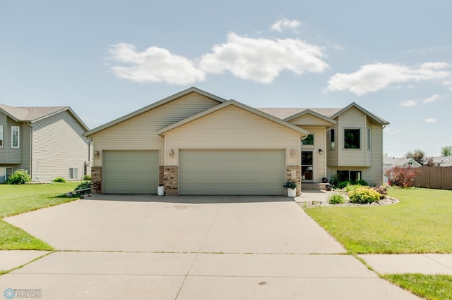 1083 Parkway Ln, West Fargo, ND 58078 - split level home with an attached garage, a front lawn, concrete driveway, and brick siding