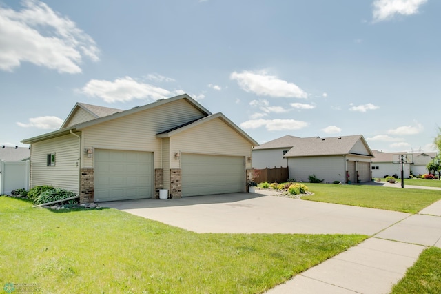 1083 Parkway Ln, West Fargo, ND 58078 - view of front facade with a garage, brick siding, and concrete driveway