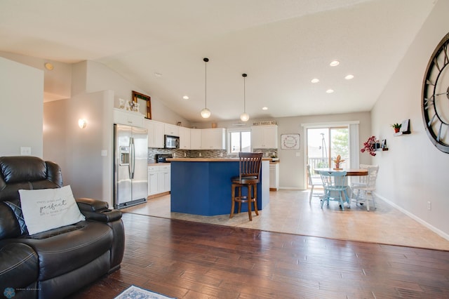 1083 Parkway Ln, West Fargo, ND 58078 - living area with lofted ceiling, light wood-style floors, and recessed lighting