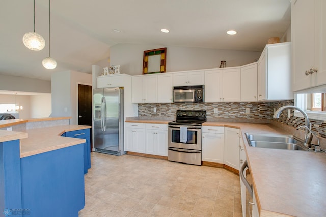 1083 Parkway Ln, West Fargo, ND 58078 - kitchen with appliances with stainless steel finishes, vaulted ceiling, light countertops, tasteful backsplash, and white cabinetry