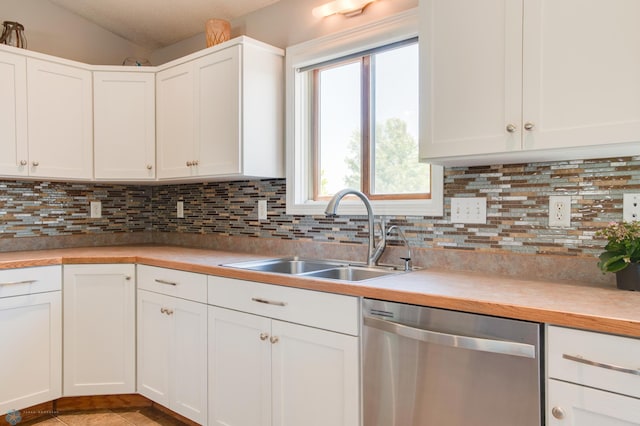 1083 Parkway Ln, West Fargo, ND 58078 - kitchen with stainless steel dishwasher, tasteful backsplash, white cabinetry, light countertops, and lofted ceiling