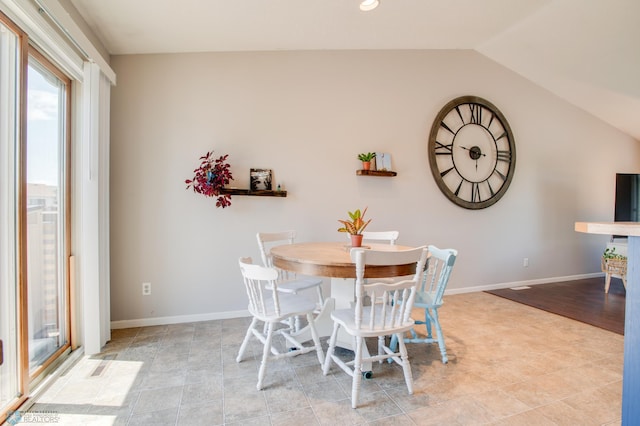 1083 Parkway Ln, West Fargo, ND 58078 - dining space featuring lofted ceiling and baseboards