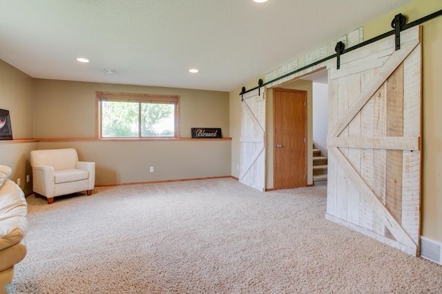 1083 Parkway Ln, West Fargo, ND 58078 - unfurnished living room with a barn door, carpet flooring, recessed lighting, and stairway