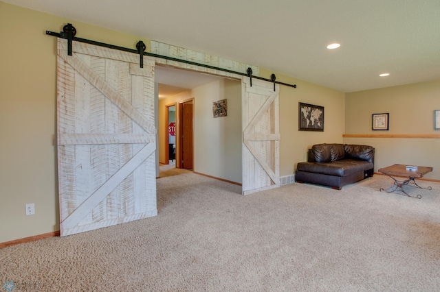 1083 Parkway Ln, West Fargo, ND 58078 - sitting room with a barn door, carpet, and recessed lighting