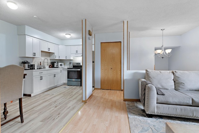 4421 Cinnamon Ridge Cir, Eagan, MN 55122 - kitchen with stainless steel electric range, light wood-type flooring, a chandelier, white cabinetry, and a textured ceiling