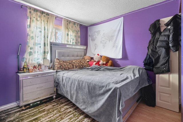 4421 Cinnamon Ridge Cir, Eagan, MN 55122 - bedroom with a textured ceiling and wood finished floors